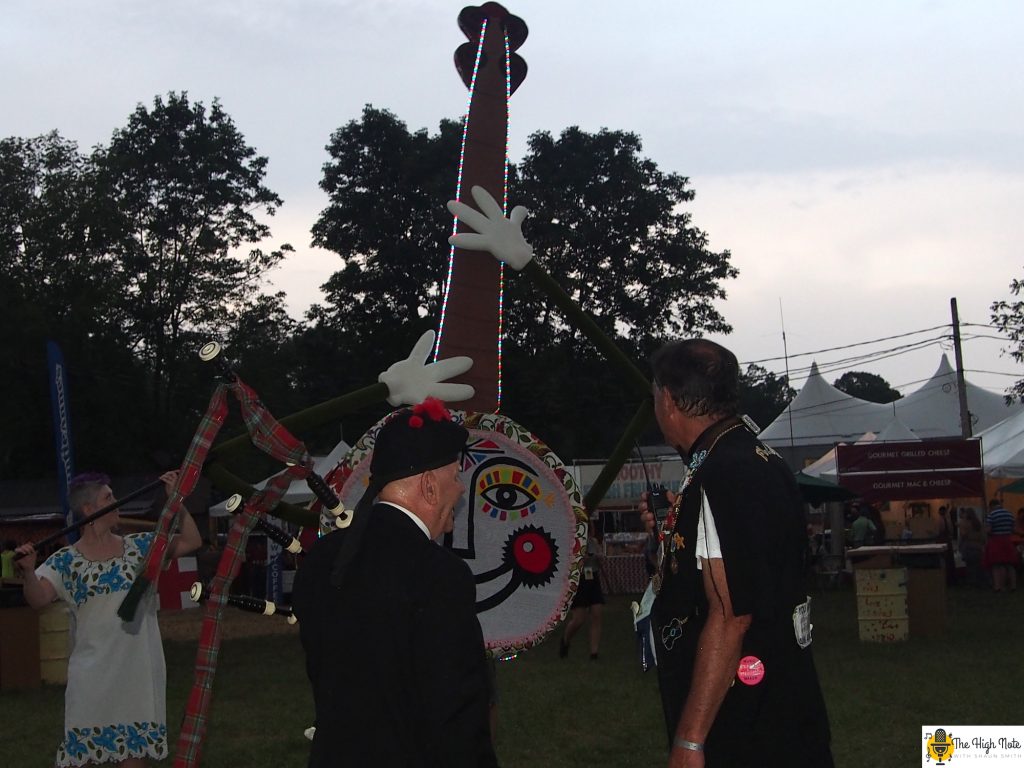 Dennis Hangey inspects Jo the Smiling Banjo at the 57th annual Philadelphia Folk Festival.