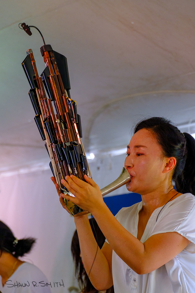 Lee Man Wol, of South Korea, playing the saenghwang with ADG7 in the Lobby Tent Sunday, Aug. 21, 2022 at the 60th annual Philadelphia Folk Festival (Shaun R. Smith/ The High Note).