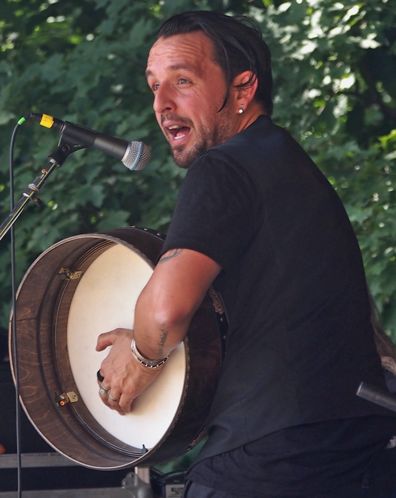 Andres Martorell of Baile An Salsa plays the bodhrán during the Celtic Workshop on the Camp Stage at the 56th annual Philadelphia Folk Festival (The High Note/ Shaun R. Smith).