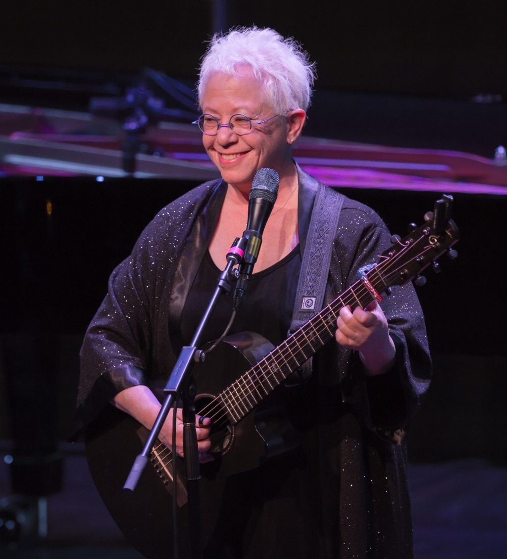 Janis Ian playing guitar on stage