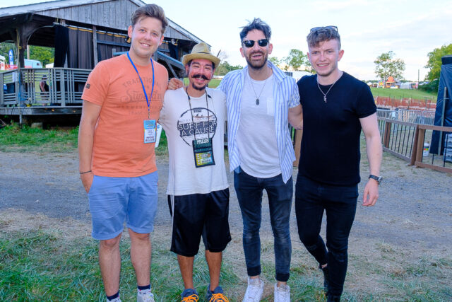 The members of Talisk Graeme Armstrong, Mohsen Amini and Benedict Morris of Glasgow, Scotland stand with Shaun Smith after recording The High Note podcast Thursday, Aug. 18, 2022 at the 60th annual Philadelphia Folk Festival.