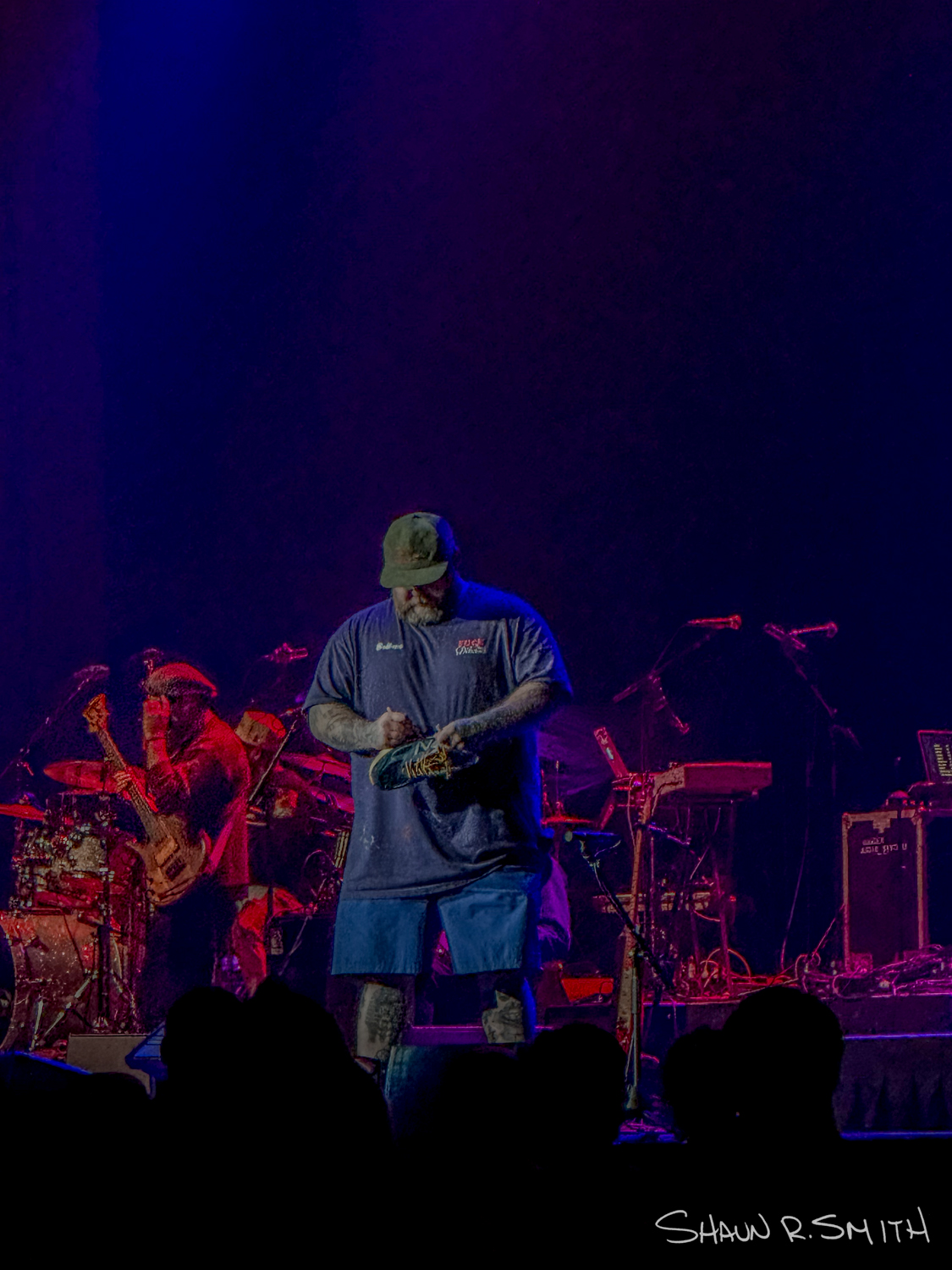 Action Bronson signs someone's New Balance shoe while performing April 20, 2024 at Hard Rock Hotel and Casino in Atlantic City